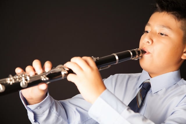 Child playing clarinet to fix overbite