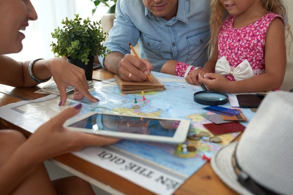 Family sitting at table budgeting for vacation