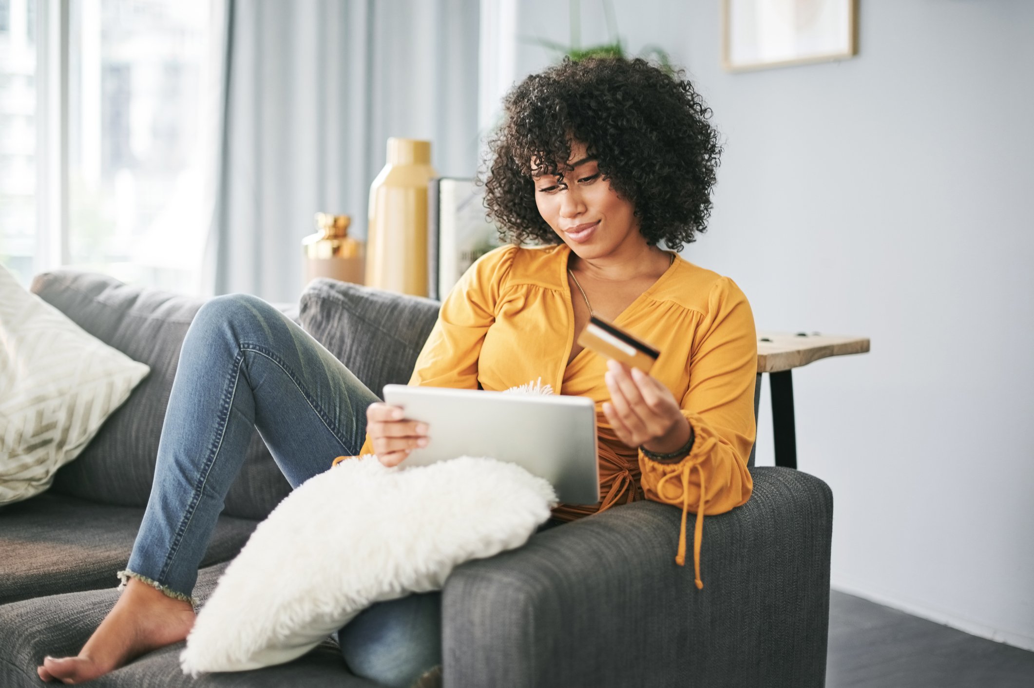 girl in yellow blouse shopping online with credit card