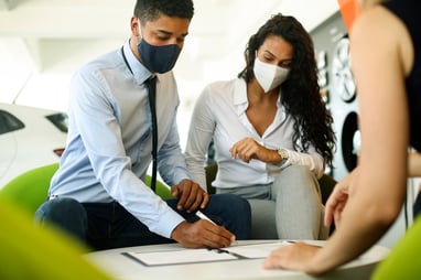 couple buying used car in south florida wearing masks