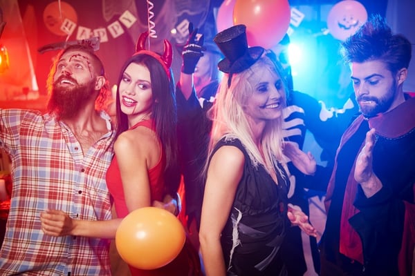 group of new friends dancing at Halloween party