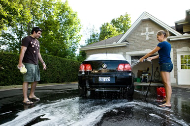 South Floridians washing car in Miami driveway