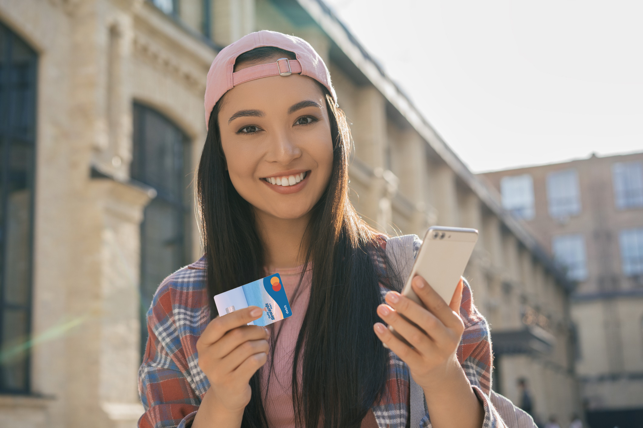 Holding Daily Rewards Debit Card with phone