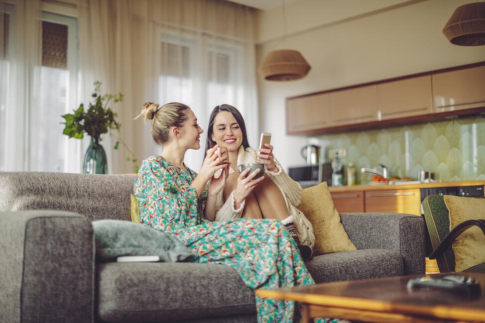 South Florida sisters shopping on phone in living room-1