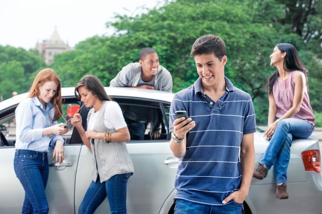 college kids hanging out around car