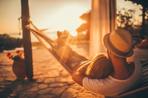 couple enjoying hammock on outdoor patio