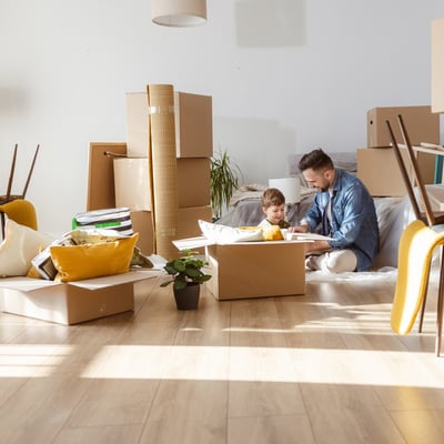 dad and son unpacking new home