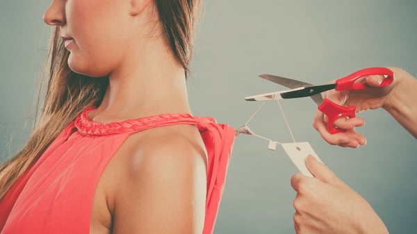 friend cutting off tag of shirt