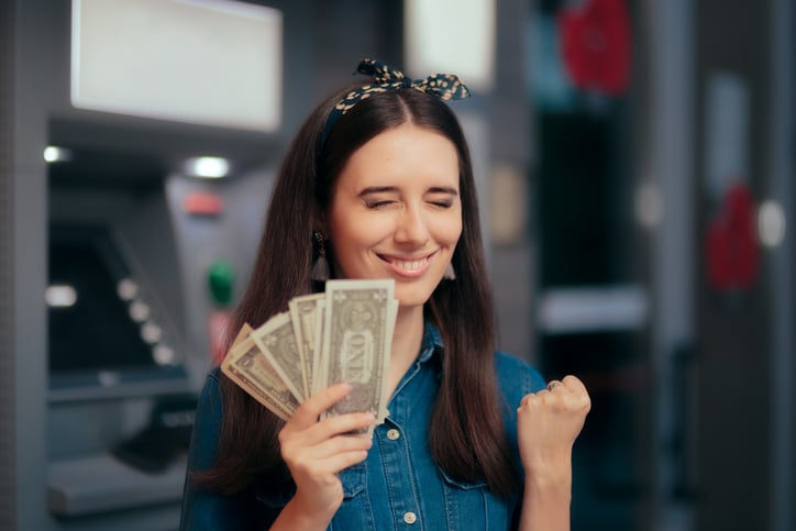 girl holding money from personal loan