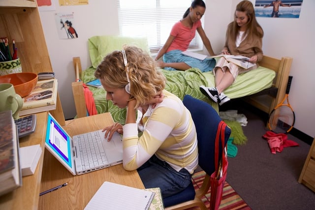 girls hanging out in college dorm room