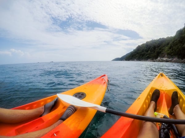 kayakers wearing watershoes while out at sea