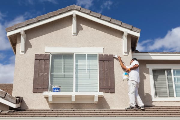 male painting exterior of florida home