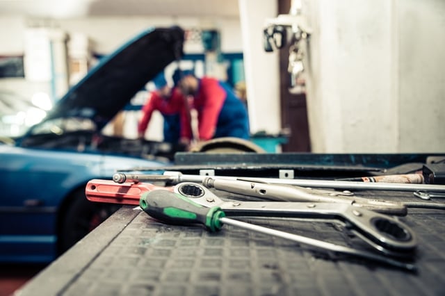 mechanics working on teen drivers car