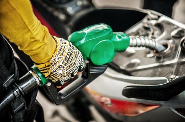 motorcyclist filling up gas tank