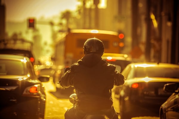 motorcylist lane splitting through traffic