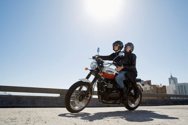 pillion riding on a motorcycle in a city