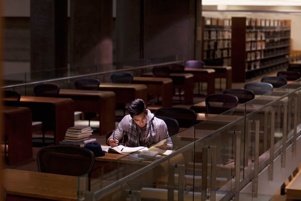 student studying in college library at night