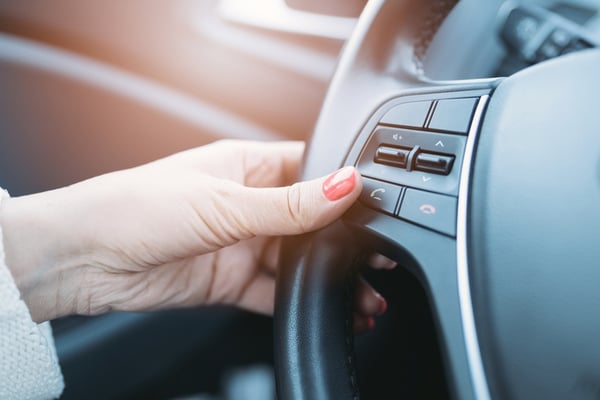 woman using voice control in car