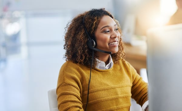 young agent working in call center wearing yellow sweater