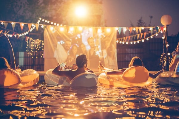 young friends light up pool party at night