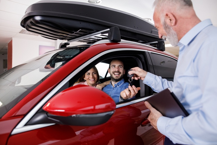 Couple receiving keys from salesman