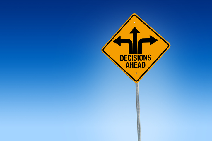 car buying decisions ahead road sign