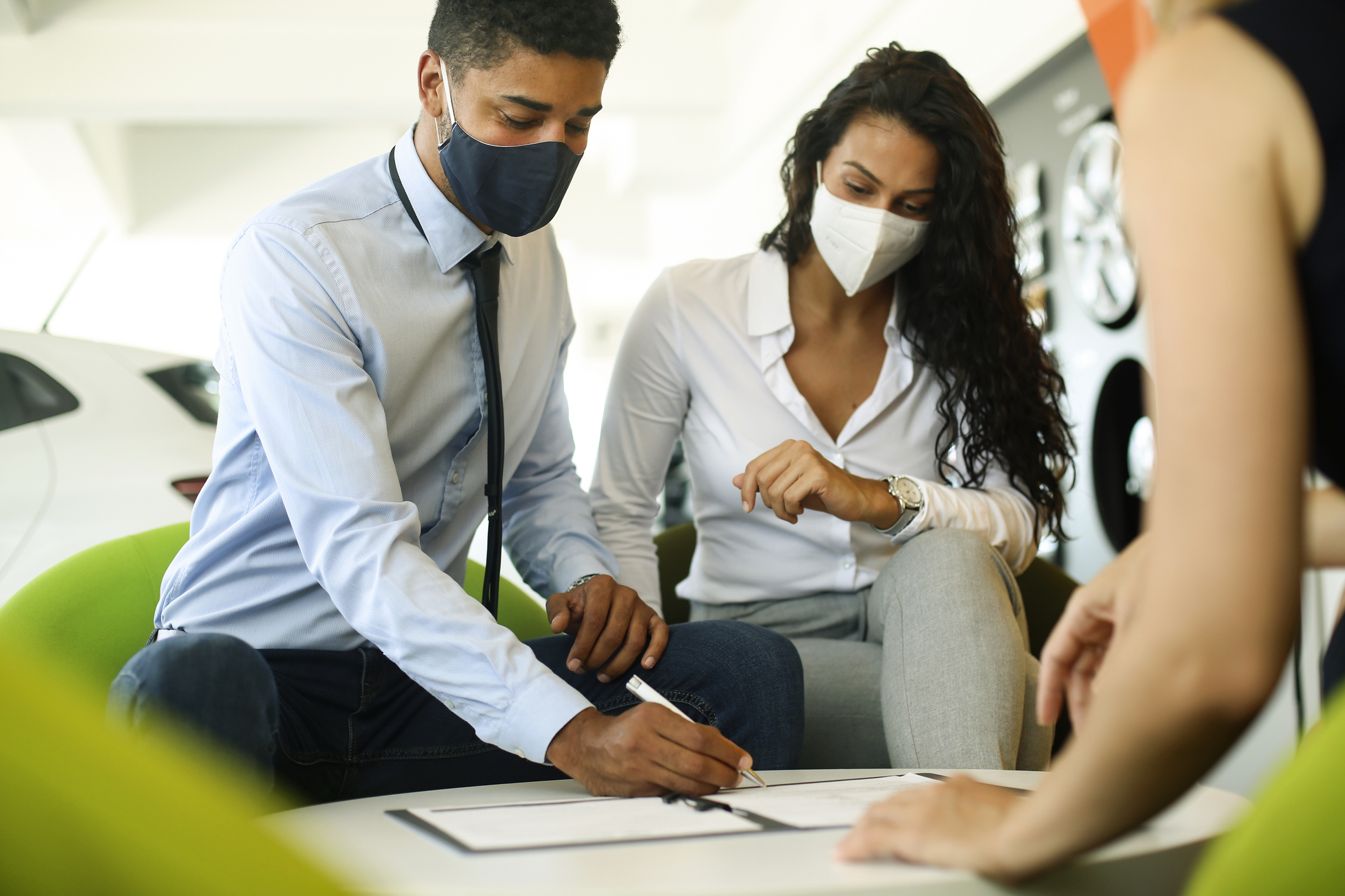 Couple wearing masks purchasing used car in florida 