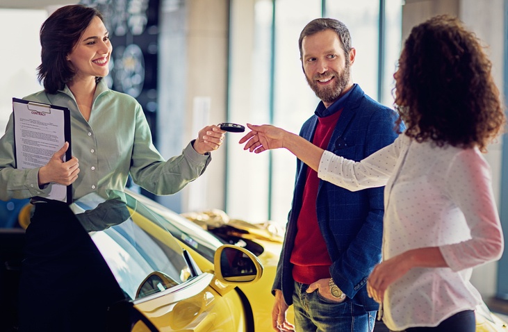 couple purchasing a car together at dealership