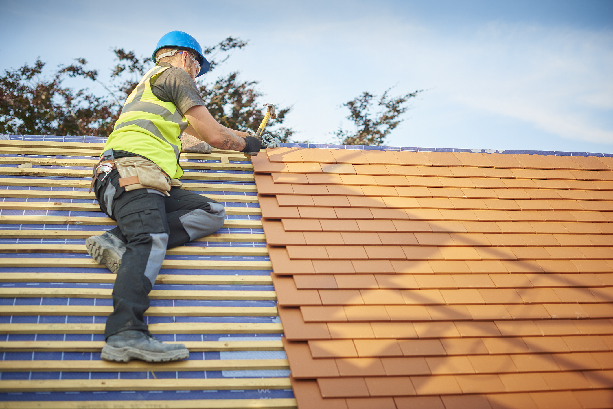 man doing roofing repairs professionally on roof