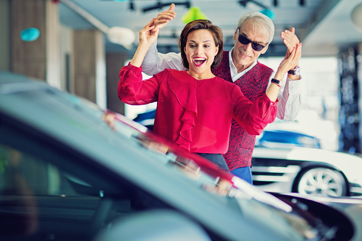 man surprising wife with new car