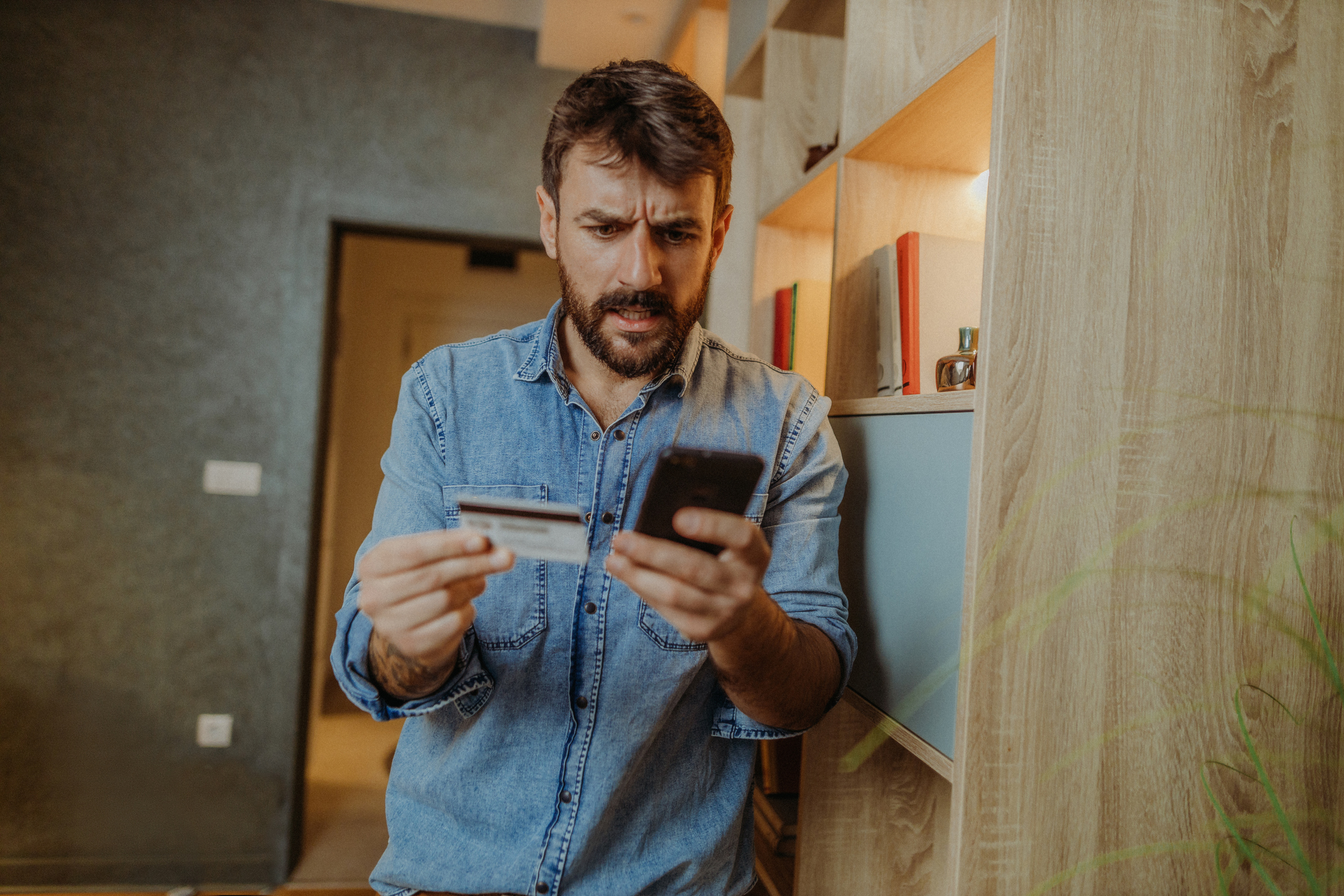 man worried about debt on cell phone with credit card
